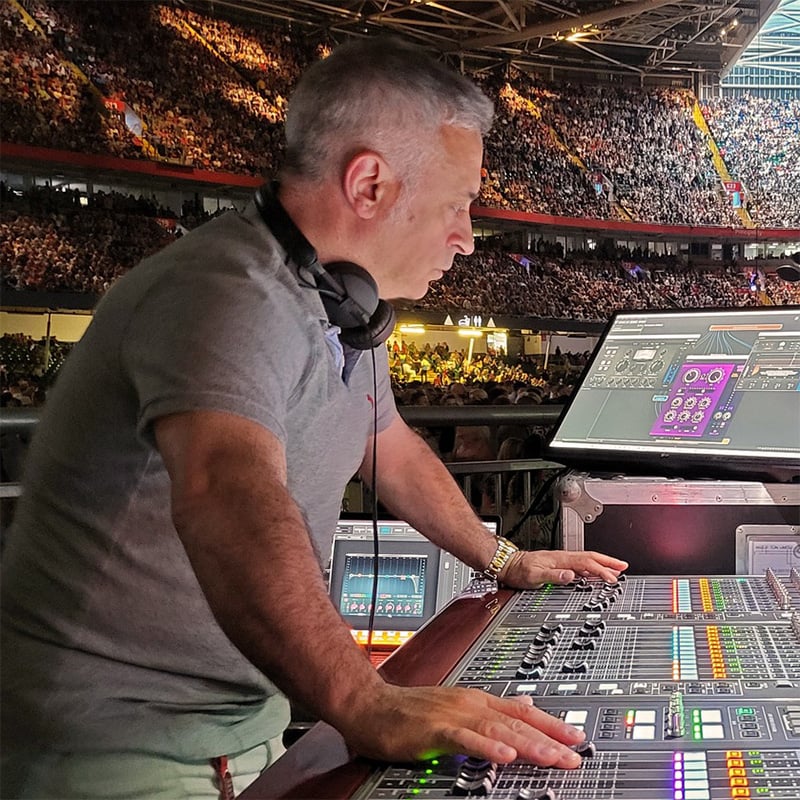 Sound engineer Matteo Cifelli mixing sound in an arena concert.