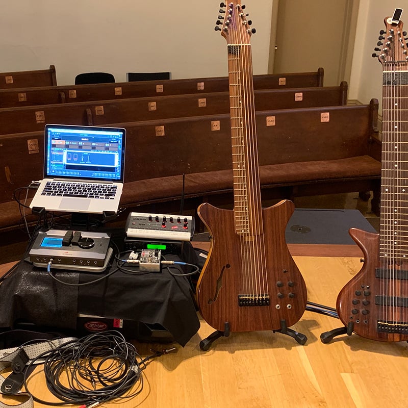 Laptop with Gig Performer on stage with two Warr Guitars