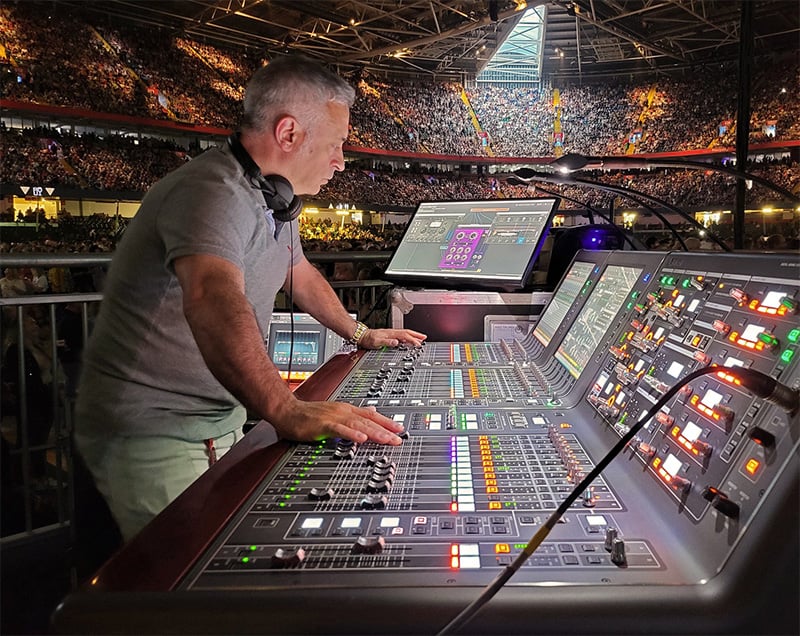 Sound engineer Matteo Cifelli mixing sound in an arena concert.